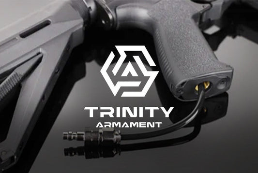 trinity armament in canada. Close-up of a firearm grip and stock with trinity armament logo on a reflective surface