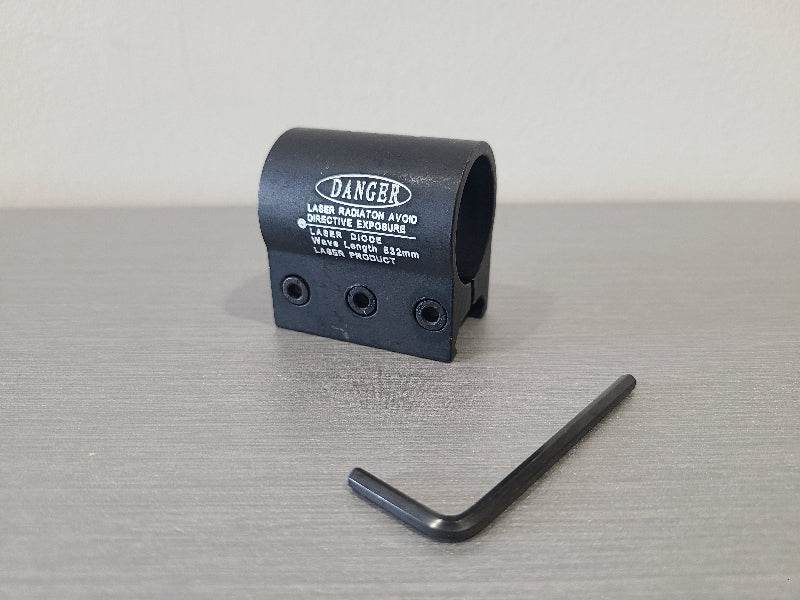 Black flashlight h9 ring accessory with warning label and included hex key tool on gray surface
