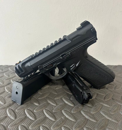 ACTION ARMY black aap-01c assasin airsoft pistol with two magazines on textured surface
