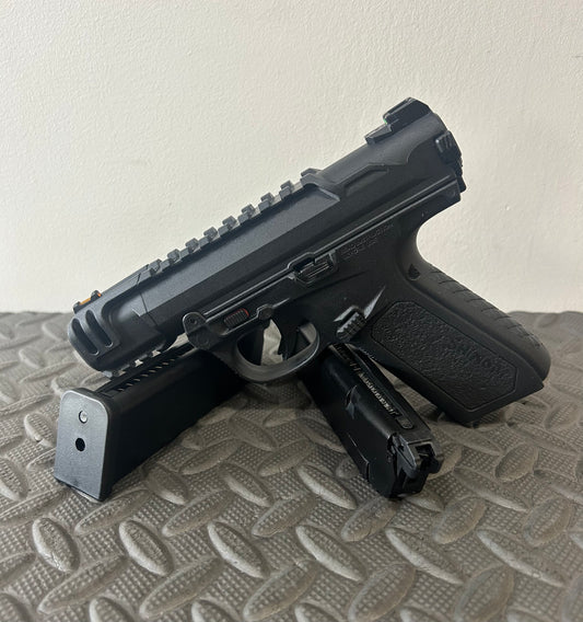 ACTION ARMY black aap-01c assasin airsoft pistol with two magazines on textured surface