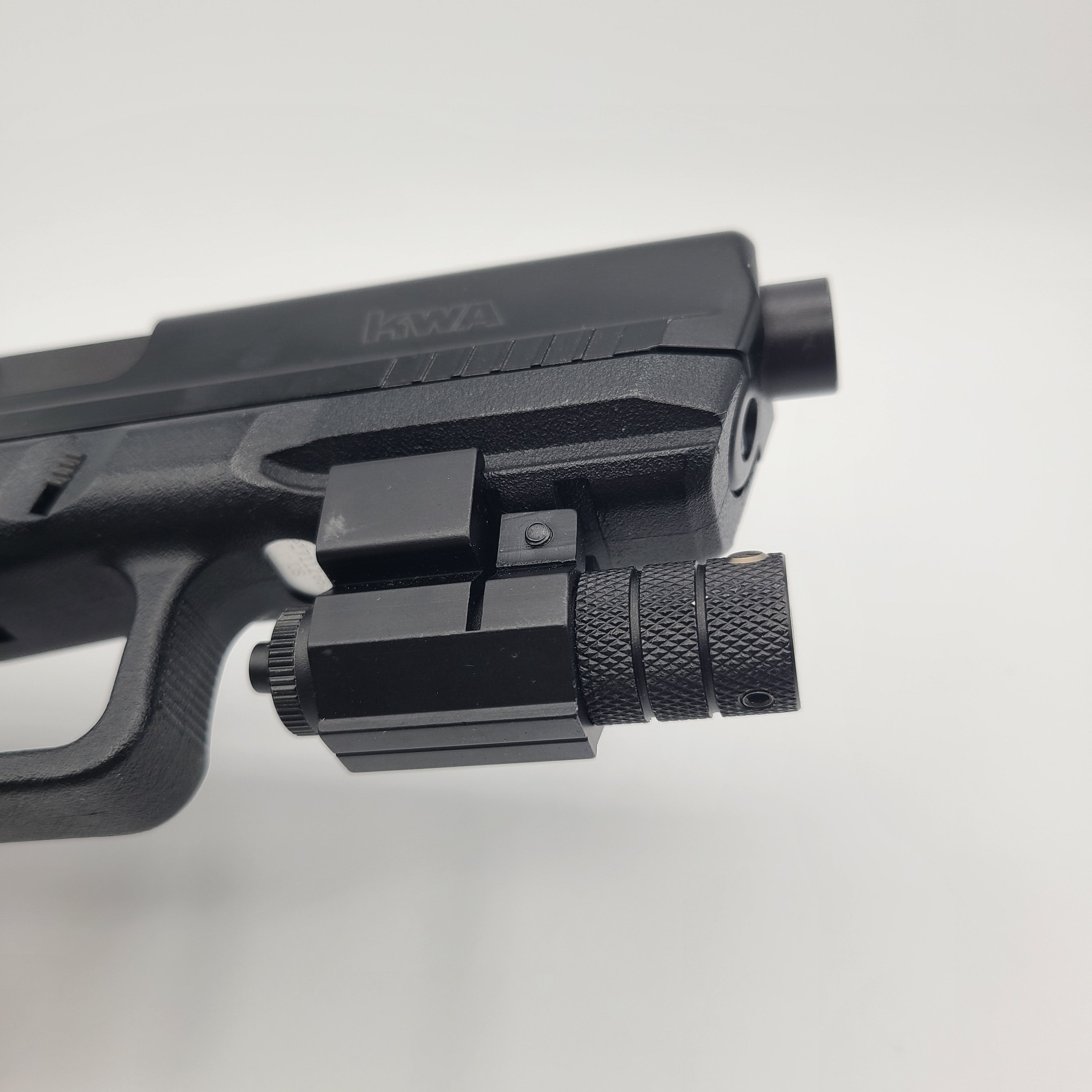 KWA airsoft pistol with tactical rail and flashlight attachment for enhanced gameplay