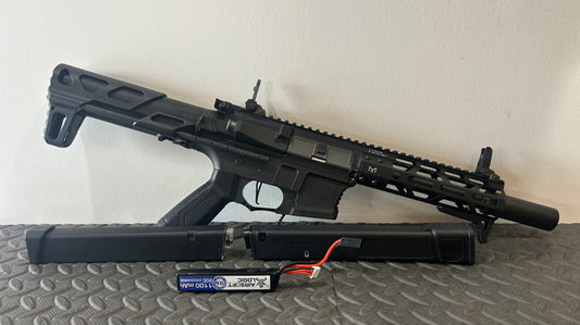 G&G AEG arp9 airsoft gun with black tactical design and battery pack on textured surface