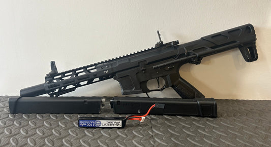 G&G AEG arp9 airsoft gun with black finish and extended handguard displayed with battery and charger