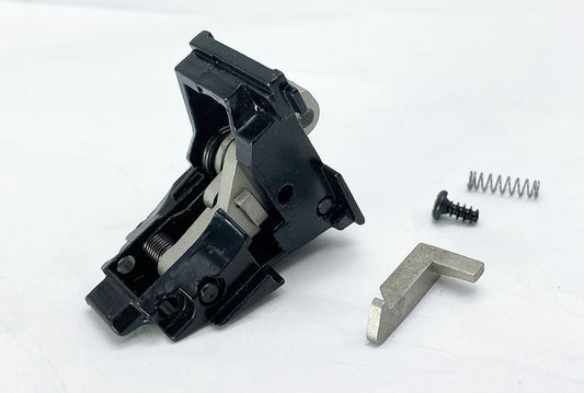 E&C hammer housing for G18 airsoft black housing assembly on white background with internal metal hammer spring and screw
