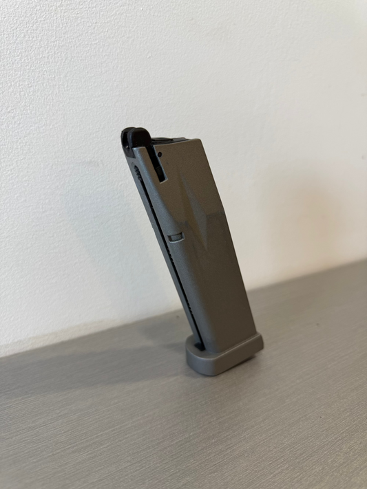 used KWC P226 X-5 CO2 magazine standing upright on gray surface showing baseplate and feed lips