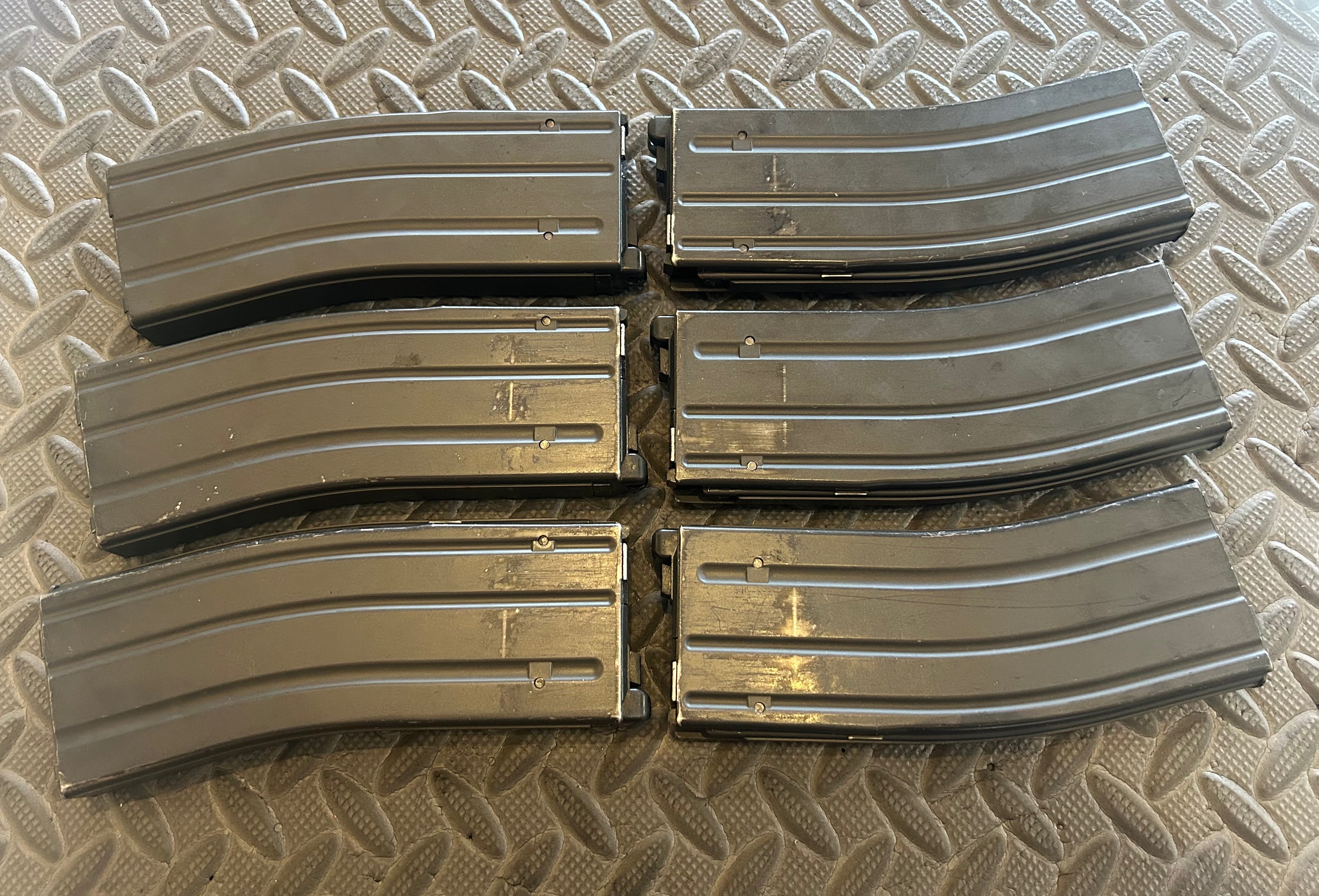 Set of six Tokyo Marui M4 MWS GBBR magazine shells for airsoft enthusiasts and tactical use
